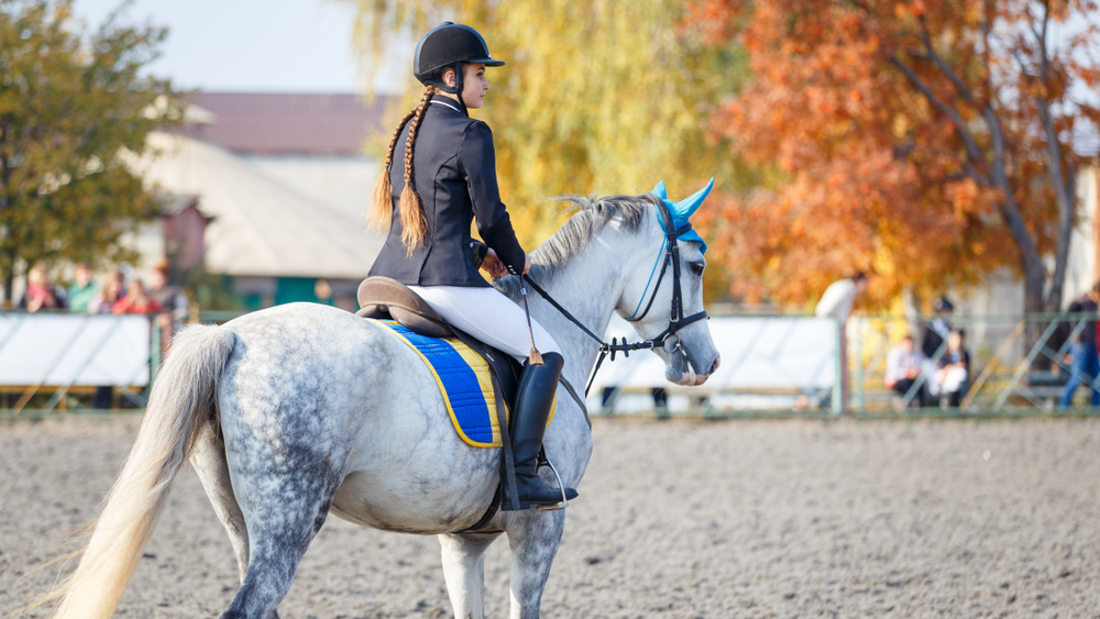 a woman riding a horse