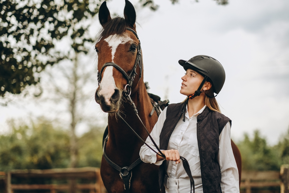 woman leading a horse